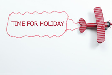 writing time for holiday red toy airplane with talk bubble on white background