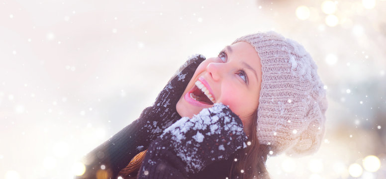 Winter girl portrait. Joyful teenage model girl having fun in winter park
