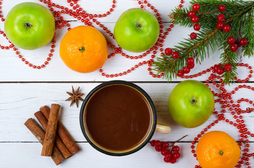 Christmas decoration and a mug with a hot drink on a wooden tabl