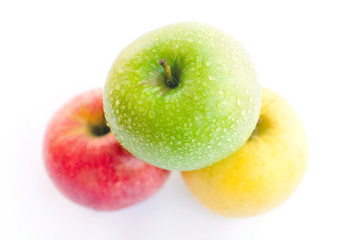 Red, green and yellow apples on white