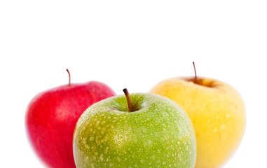 Red, green and yellow apples on white