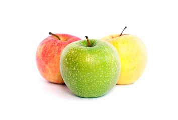 Red, green and yellow apples on white