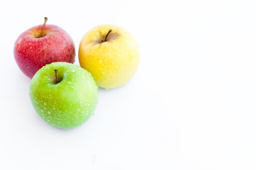 Red, green and yellow apples on white