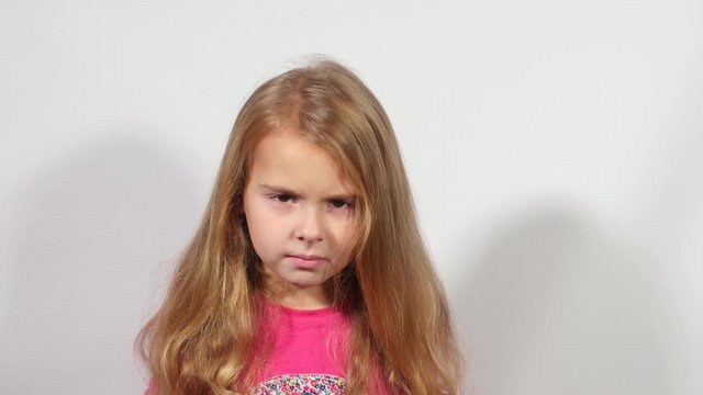 Positive and negative emotions of child. Charming little girl shows range of human emotions. 
