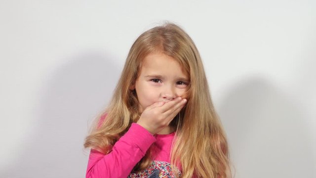 Cute girl shows different emotions. Girl with long blond hair gesticulates. A lot of gestures and facial expressions of girl in a natural manner.