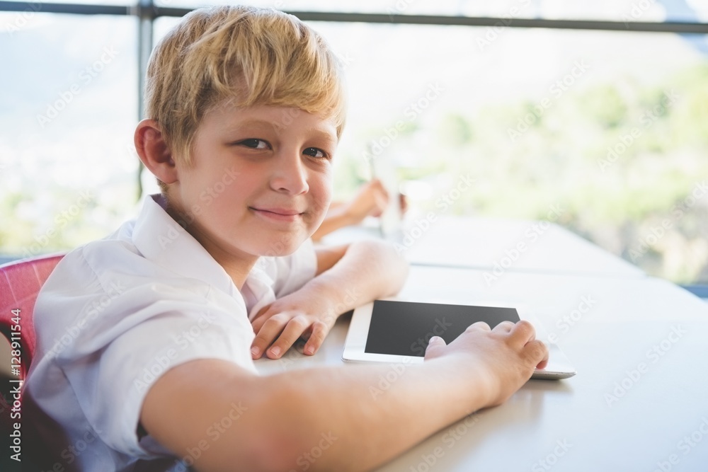 Poster schoolkid using digital tablet in classroom