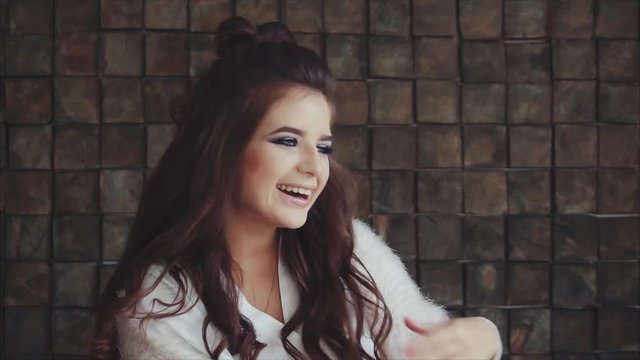 Young pretty woman brunette looking to the camera and histrionic laughing slow motion