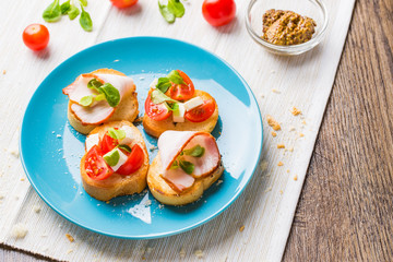 Bruschetta with tomato, cheese and bacon