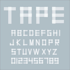 White transperent adhesive tape letters isolated on grey background.