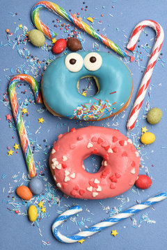 Funny glazed donuts on blue background