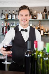 Waiter holding a glass of wine