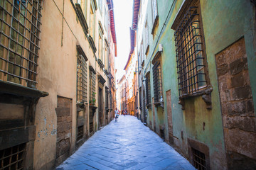 Fototapeta na wymiar Old beautiful empty narrow streets in small city of Lucca in Italy