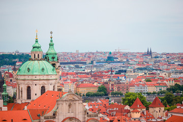 Fototapeta premium Beautiful view of ancient building with red roofs in Prague, Czech Republic