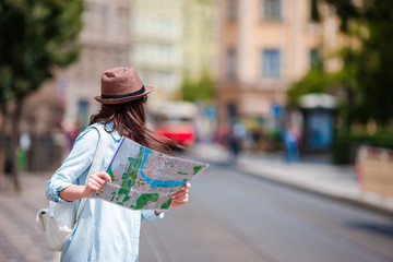Young woman looking at touristic citymap. Happy girl enjoy vacation holiday in Europe.