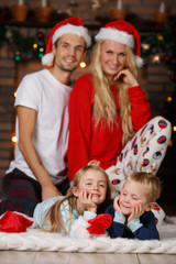 Smiling family at Christmas tree