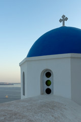Fototapeta na wymiar Church with blue roof in town of Oia and panorama to Santorini island, Thira, Cyclades, Greece
