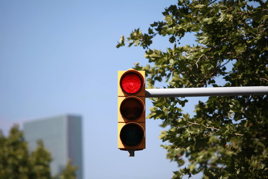 Red traffic light on the background of  blue sky