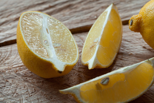 Lemon on old wooden table, selective focus