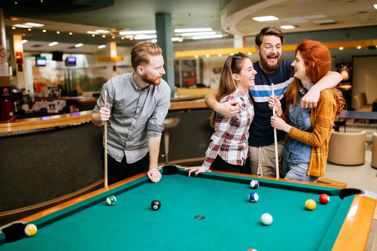 Group of people playing snooker