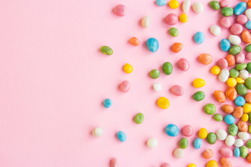 Sweets scattered on pink background