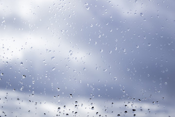 Rain drops on window on a cloudy day