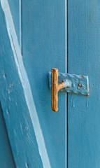Part of a blue wooden door