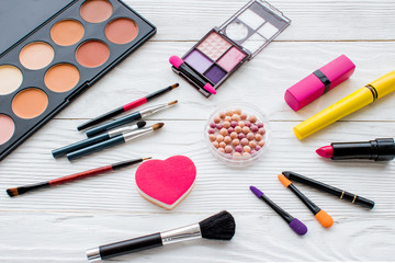 set of decorative cosmetics on wooden background top view