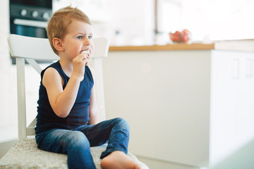 Child earing icecream in living room