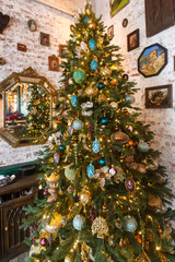 Christmas tree decorated with toys in the corner of the room.