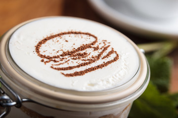 Concept: restaurant menus, healthy eating, homemade, gourmands, gluttony. Tiramisu dessert with cookies on weathered wooden table.