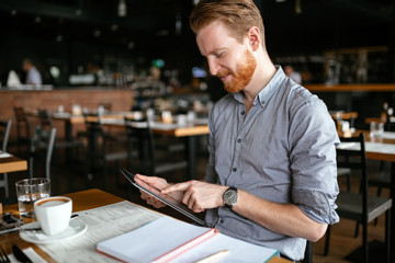 Businessman taking notes in cafe