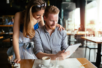Beautiful couple looking at tablet