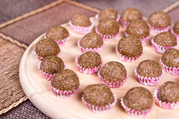 Chocolate balls with coconut in paper baskets
