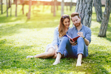 Lovely university students studying outdoors