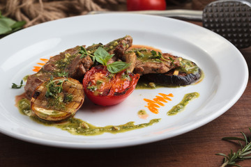 Concept: restaurant menus, healthy eating, homemade, gourmands, gluttony. White plate of veal medallions with grilled vegetables and 