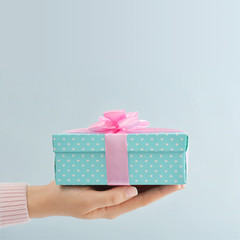 Female hands with gift box
