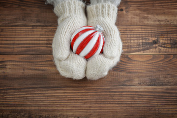 Red christmas ball in female hand closeup