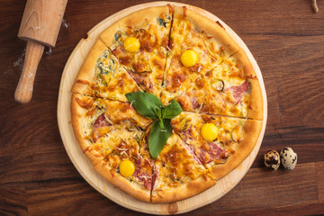 Concept: restaurant menus, healthy eating, homemade, gourmands, gluttony. Pizza carbonara on a wooden vintage table with ingredients. Top-down view