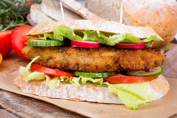 sandwich with fried meat and vegetables