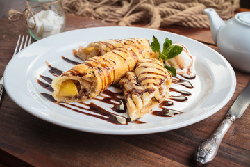 Concept: restaurant menus, healthy eating, homemade, gourmands, gluttony. White plate of strudel with apple on vintage wooden table.