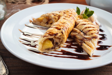 Concept: restaurant menus, healthy eating, homemade, gourmands, gluttony. White plate of strudel with apple on vintage wooden table.