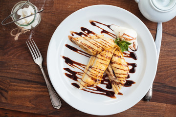 Concept: restaurant menus, healthy eating, homemade, gourmands, gluttony. White plate of strudel with apple on vintage wooden table. Top-down view