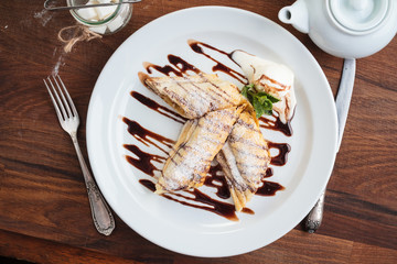 Concept: restaurant menus, healthy eating, homemade, gourmands, gluttony. White plate of strudel with apple on vintage wooden table. Top-down view