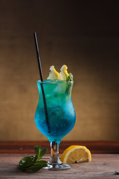 Concept: restaurant menus, healthy eating, homemade, gourmands, gluttony. Blue Lagoon Cocktail on gritty vintage background.