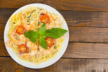 delicious delicious spaghetti with shrimps and basil on  plate