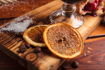 Concept: restaurant menus, healthy eating, homemade, gourmands, gluttony. Slices of dried orange with sugar on weathered wooden background