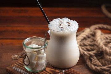 Concept: restaurant menus, healthy eating, homemade, gourmands, gluttony. Milk shake with ingredients and vintage cutlery on wooden background.