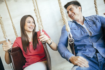 Young couple relaxing in swing