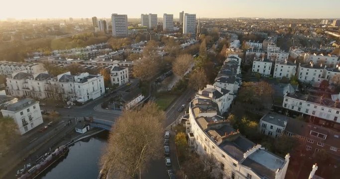 Aerial push out view of an elegant residential area in London by a canal