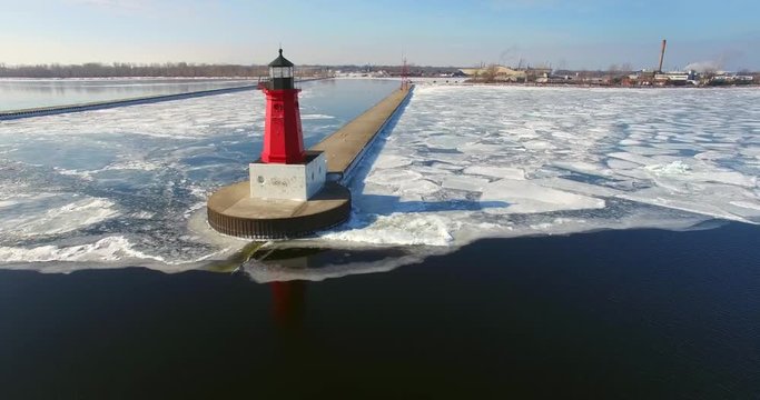 Icy winter flyby of Menominee North Pier Lighthouse. This lighthouse marks the mouth of the Menominee River running between Marinette Wisconsin and Menominee Michigan.
